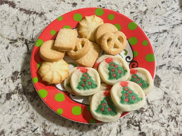 Store-bought holiday cookies sitting on a festive holiday plate.