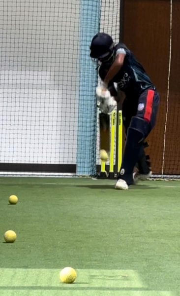 Cricketer Aaryan Salunke practices batting.